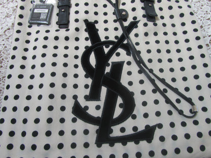polkadot tote bag with YSL logo on a lace background 