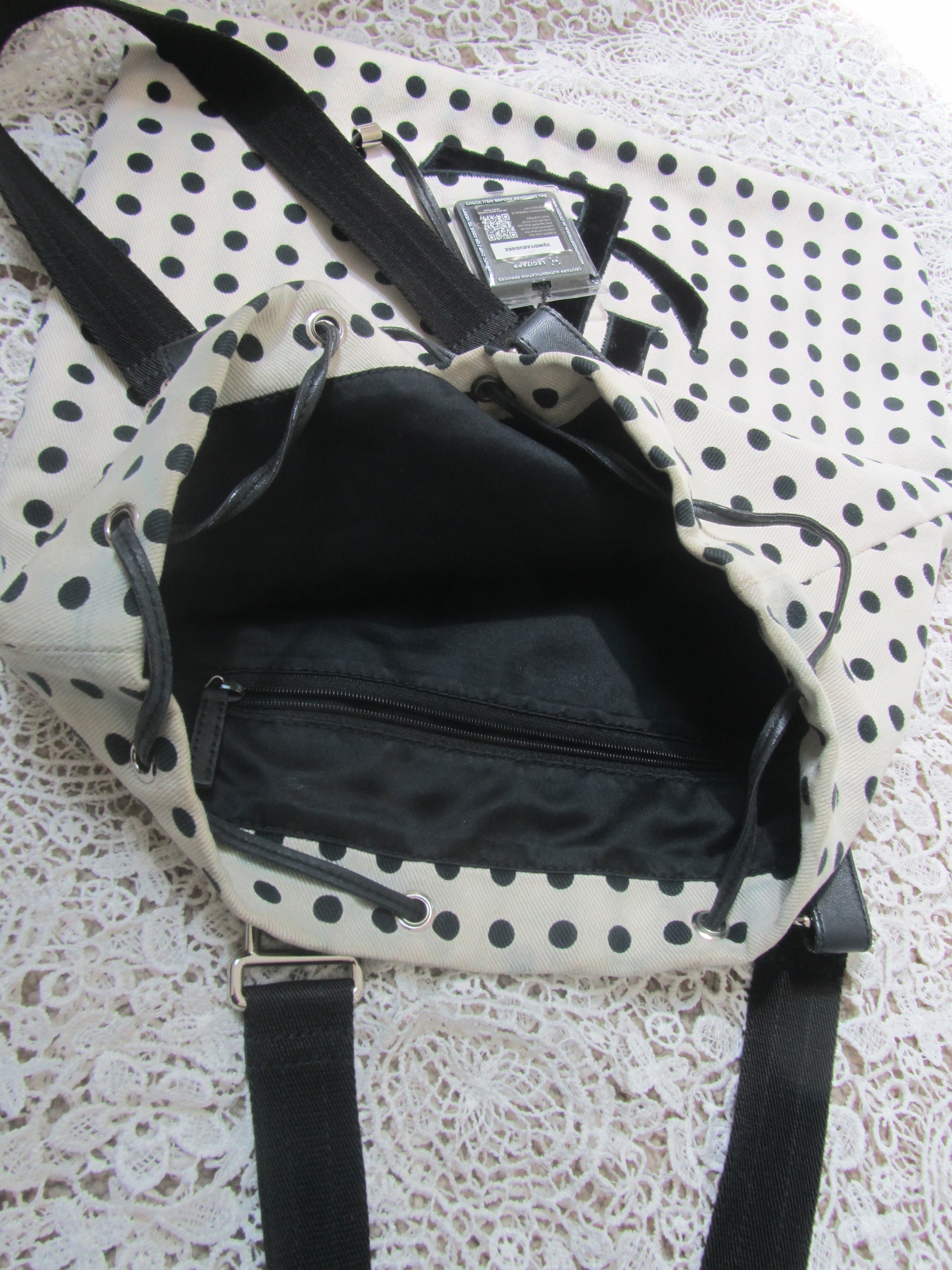 interior of a polkadot tote bag  on a lace background 