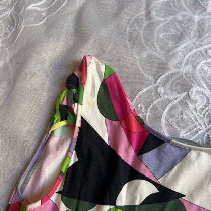 Colorful scarf with geometric pattern on a textured fabric background