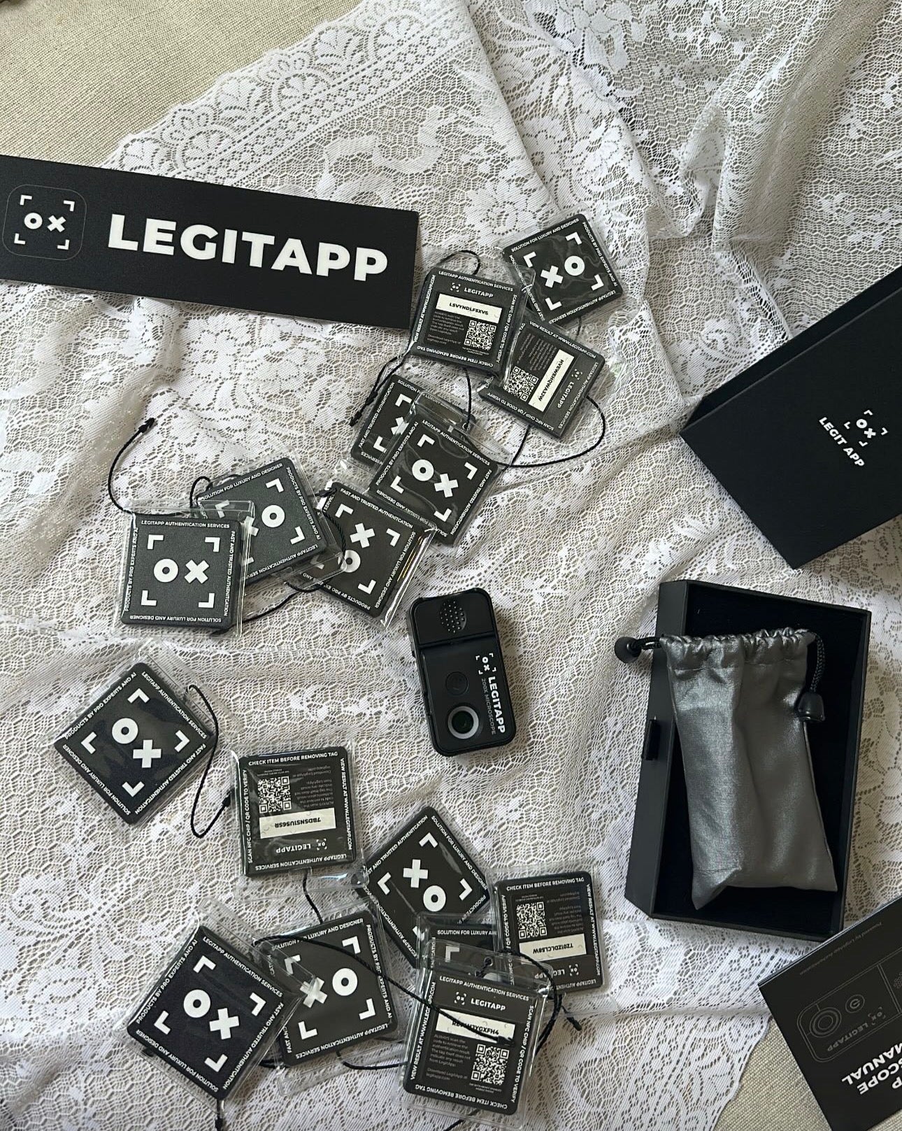 Collection of LEGITAPP devices and packaging on a textured surface