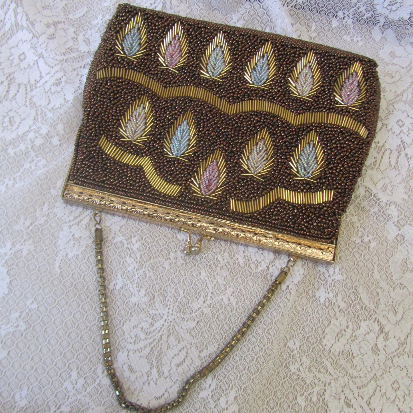 Decorative handbag with beadwork on a textured surface
