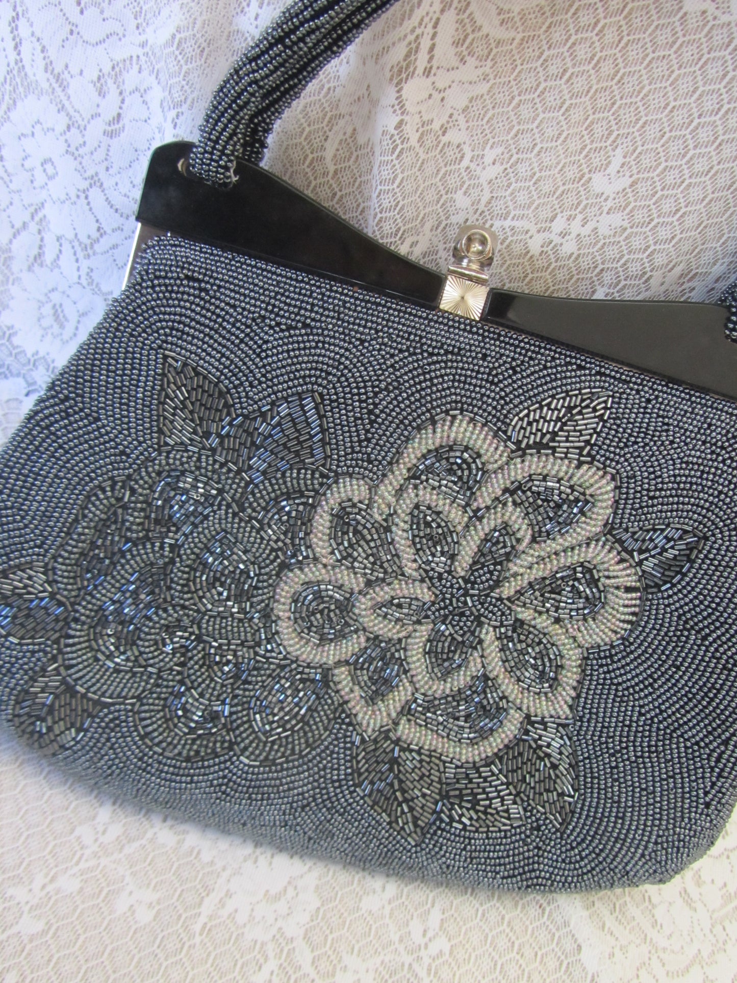 Beaded handbag with floral design on a textured surface