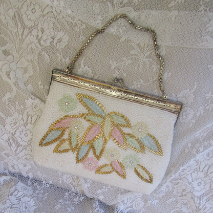 Embroidered clutch bag on a textured lace background