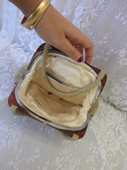 Hand holding a small, open bag with a textured white surface in the background