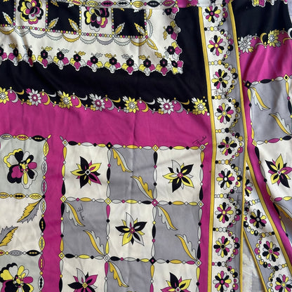 Decorative fabric with floral and geometric pattern in black, yellow, pink, and white.