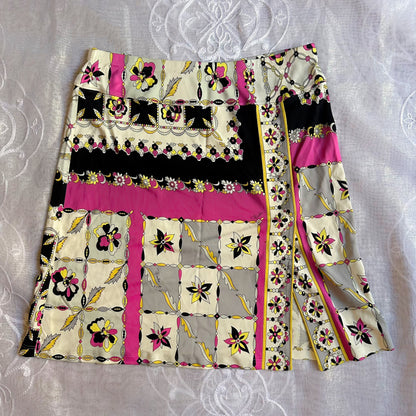 Colorful patterned fabric with pink, black, and yellow design on a textured white background