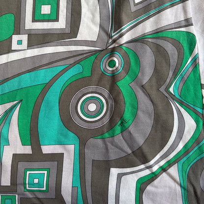 Close-up of a fabric with geometric pattern in green, gray, and white.