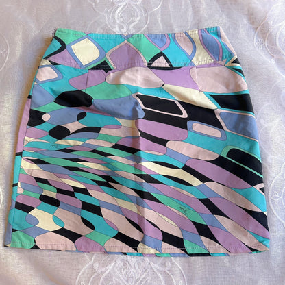 Colorful patterned skirt on a textured white background