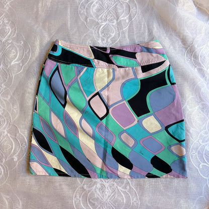 Colorful patterned skirt on a textured white background