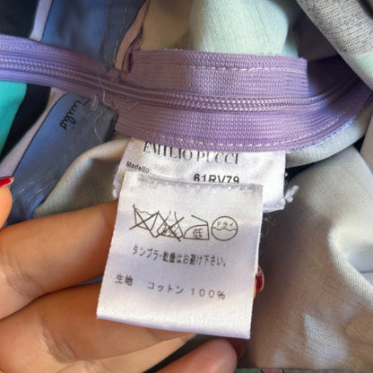 Close-up of a clothing tag on a garment with visible brand name.