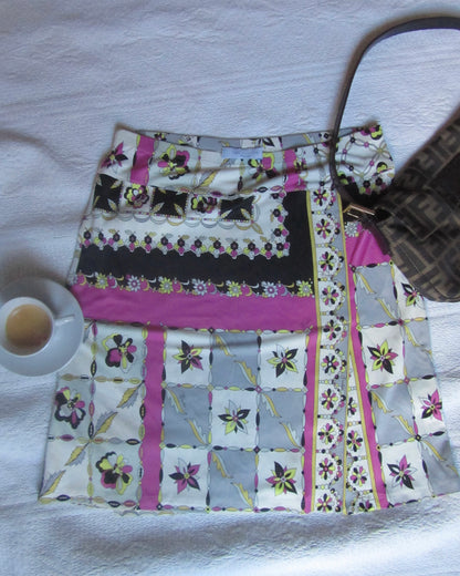 Colorful quilted skirt with floral patterns on a white surface