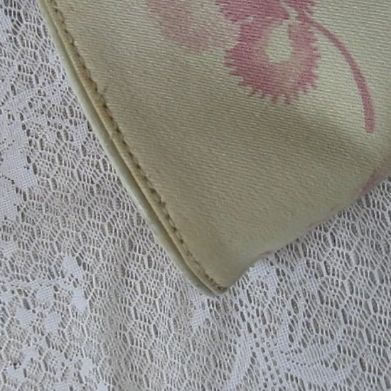 pink floral handbag on a lace background