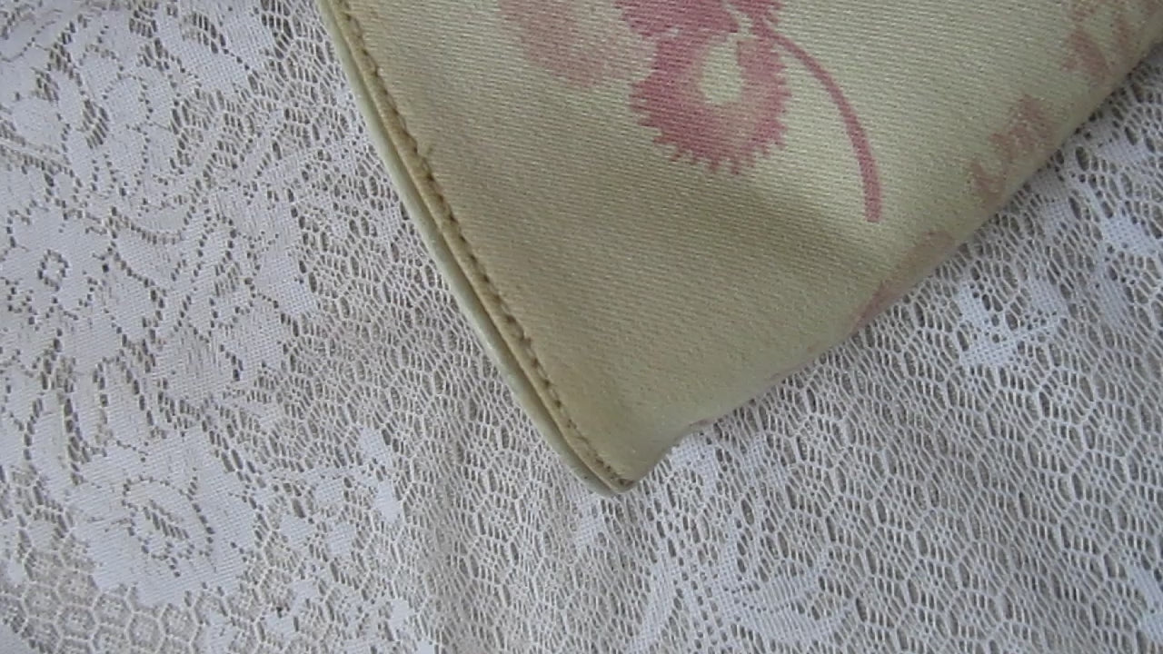 pink floral handbag on a lace background