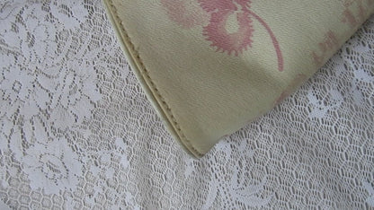 pink floral handbag on a lace background