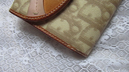 dior heart detailed wallet on a lace background