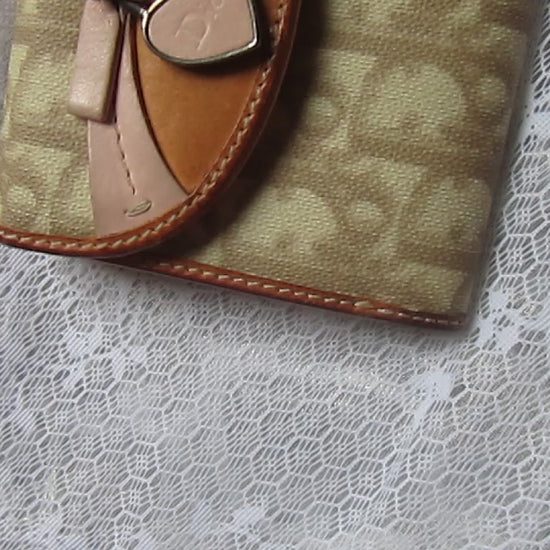 dior heart detailed wallet on a lace background