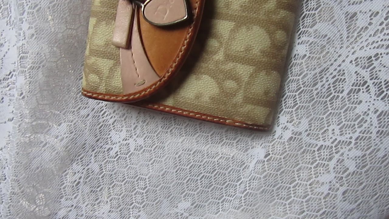 dior heart detailed wallet on a lace background