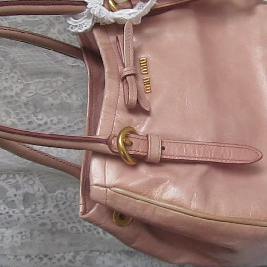 pink handbag on white lace background