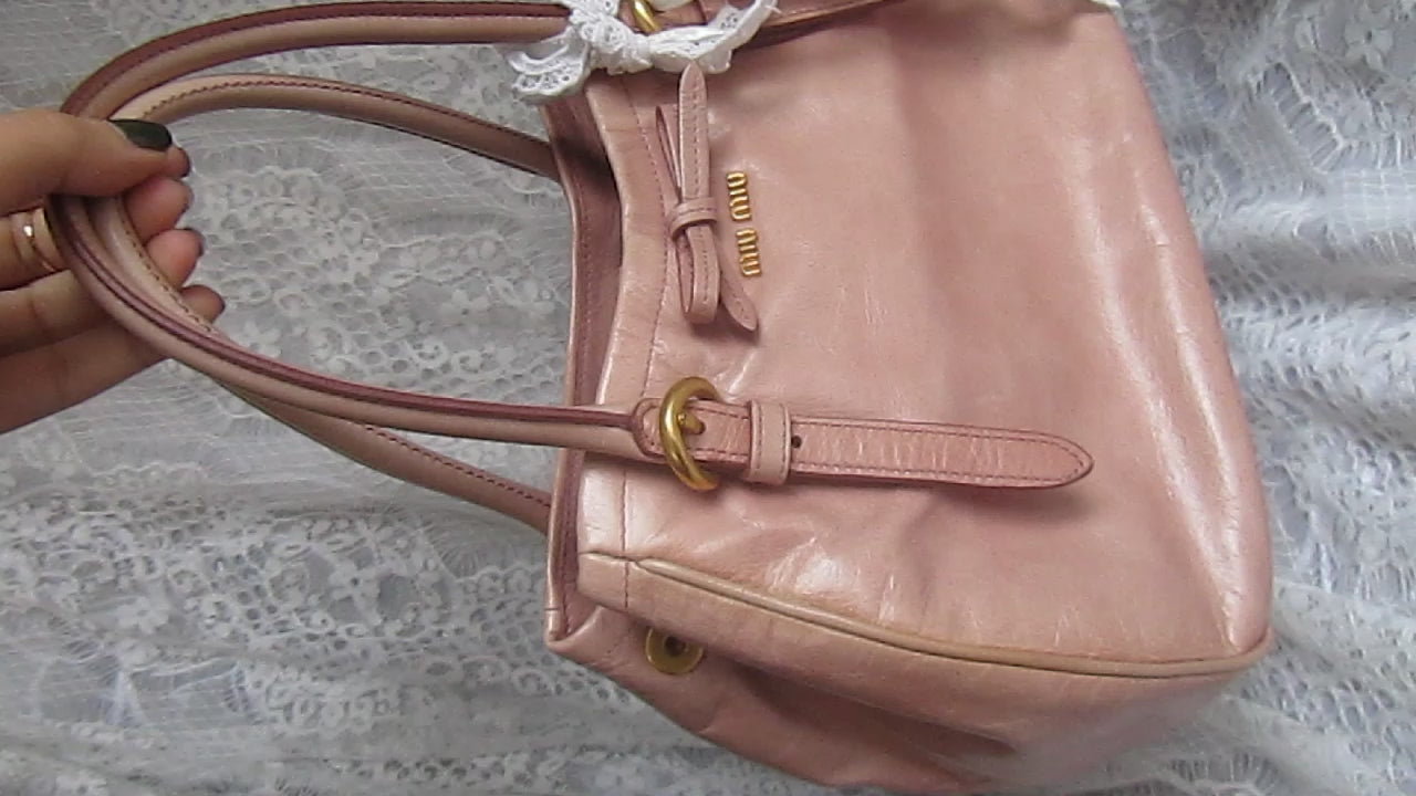 pink handbag on white lace background