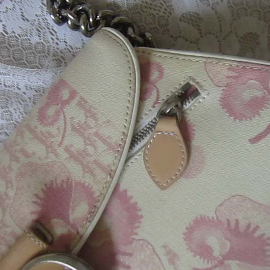 pink floral handbag on a lace background