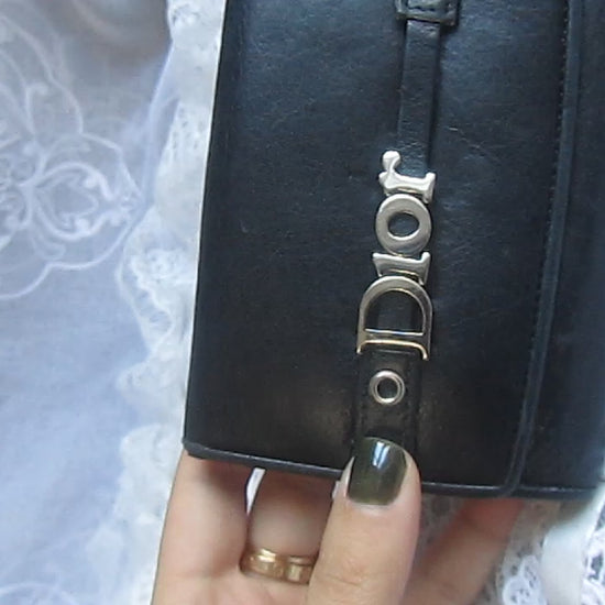 dior black wallet on a lace background