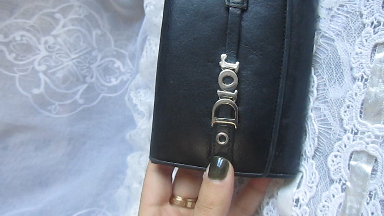 dior black wallet on a lace background